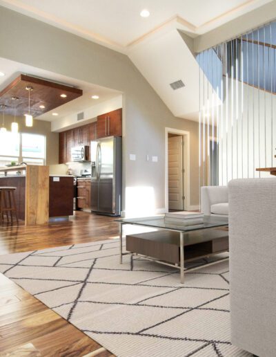 Modern living room interior with open-plan kitchen and high ceiling.